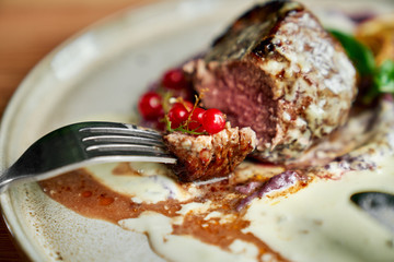Roast duck on plate in restaurant.
