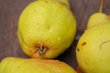 yellow pears on wooden table