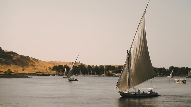 Traditional Egyptian sailboat sailing on a Nil river near Aswan, Egypt