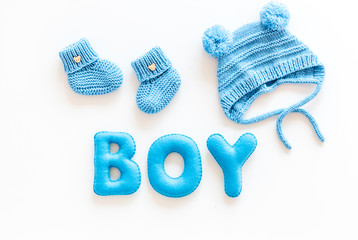 Children's birthday concept. Word boy near booties on white background top view