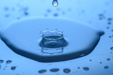 water splashes on glass on a blue background drops of water