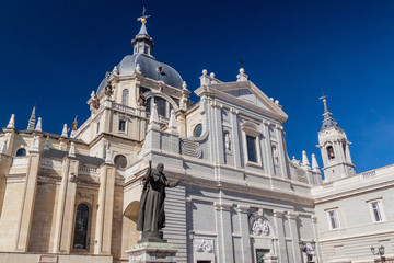 Fototapeta na wymiar Catedral de la Almudena cathedral and John Paul II statue in Madrid, Spain