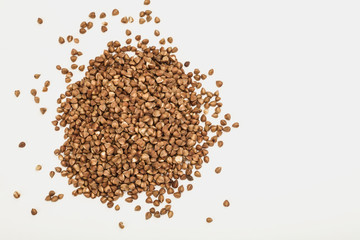 handful of buckwheat on a white table