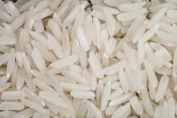 handful of white rice on a white table
