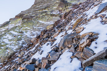 Rocks and snow at the slopes of Coma Pedrosa, highest mountain in Andorra