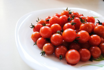 small red tomatoes in a plate