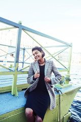 young pretty indian girl posing cheerful at pier in city, lifestyle people concept