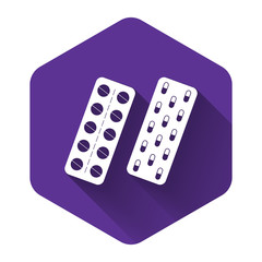 White Pills or capsules in blister package icon isolated with long shadow. Tablets in package. Medications Accessory pharmacies and first aid kits. Purple hexagon button. Vector Illustration
