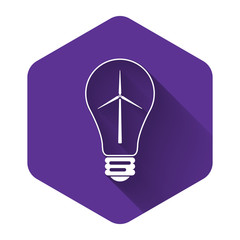 White Light bulb with wind turbine as idea of eco friendly source of energy icon isolated with long shadow. Alternative energy concept. Purple hexagon button. Vector Illustration