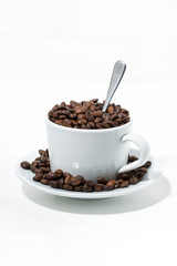 cup with coffee beans on white background, concept photo, vertical