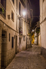 Evening in a narrow alley in the center of Granada, Spain