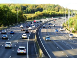 Tilt shift photograph of the M25 London Orbital Motorway near Junction 17 in Hertfordshire, UK - obrazy, fototapety, plakaty