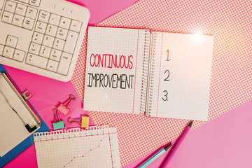 Word writing text Continuous Improvement. Business photo showcasing ongoing effort to improve products or processes Writing equipments and computer stuffs placed above colored plain table