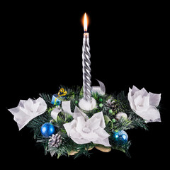 handmade festive decoration with decorative ribbons, white flowers, blue balls, Christmas tree branches, kidrovymi cones and a burning candle, on a black background