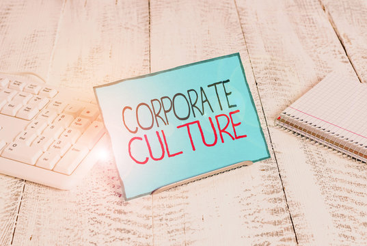 Writing note showing Corporate Culture. Business concept for pervasive values and attitudes that characterize a company Notepaper on wire in between computer keyboard and sheets