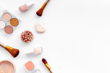 Makeup concept. Frame with decorative cosmetics and brushes on white background top view copy space