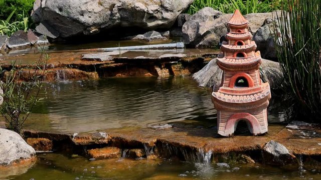 Waterfall on the Chinese Monera in the garden decor