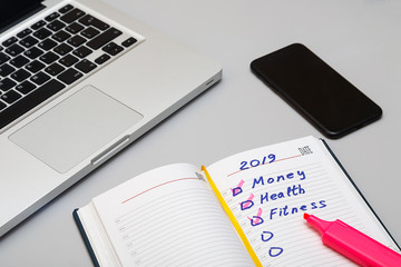 Opened daily organizer with with complete task on the grey background