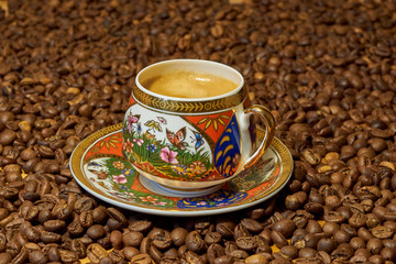 cup of coffee on coffee beans