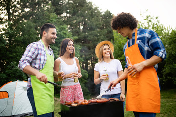 Small group of friends having fun at barbecue party