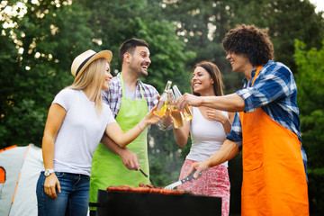 Fototapeta premium Group of happy friends having outdoor barbecue party and fun together