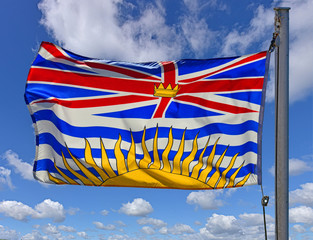 Flag of the province of Britich Columbia, Canada on a flagpole flying in the wind.