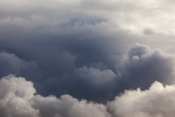 Dark puffy cloud layers and sky background