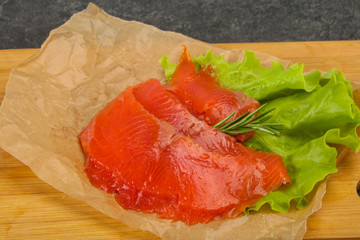 Sliced salmon fillet served rosemary