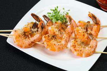 Grilled prawn skewer with sauce