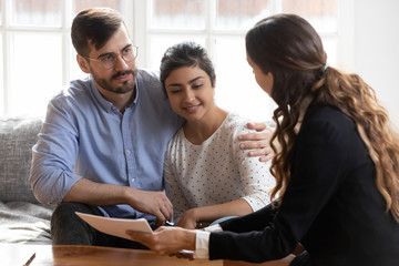 Realtor or financial advisor consulting diverse couple about deal