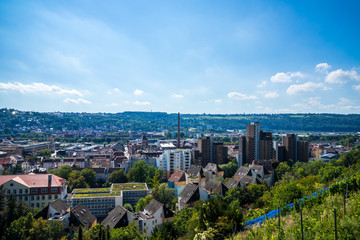 Germany, Wide aerial view above roofs of houses, buildings and skyscrapers of medieval city esslingen am neckar from above on sunny day with blue sky, seen from vineyards