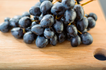 bunch of grapes on wooden table