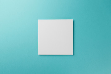 Creative layout made of paper blank on pastel on blue background. Top view. Flat lay. Copy space. Colorful background. Minimal creative concept. AI Aqua - trendy color of the year 2021