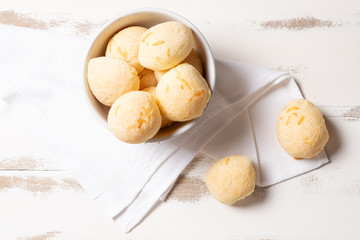 Brazilian snack cheese bread, Homemade cheese buns in arustic style, vintage white wooden background