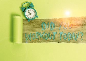 Handwriting text writing Did You Workout Today. Conceptual photo asking if made session physical exercise Alarm clock and torn cardboard placed above a wooden classic table backdrop