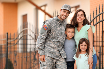 Happy military man with his family outdoors