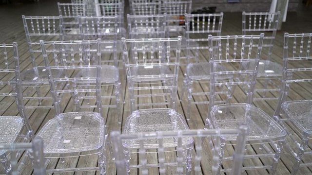 Transparent plastic chairs for wedding guests.