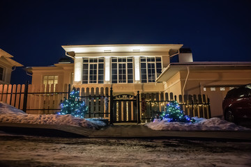 Decorative lighting of the cottage at winter