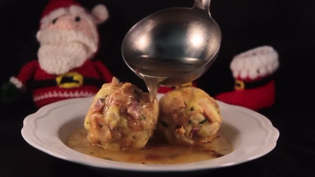 two beautiful knodels in broth with Santa Claus in the background