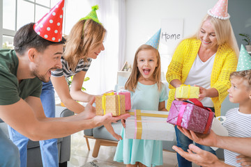 Big family greeting little girl with Birthday presents at home