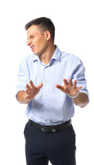 Portrait of handsome young businessman rejecting something on white background