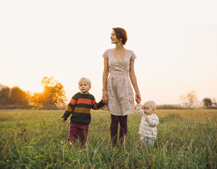Family on nature. Mother with children outdoors.