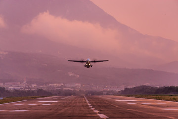 Fototapeta na wymiar Sunset view of Airport of Tivat, Montenegro, with take-off planes.