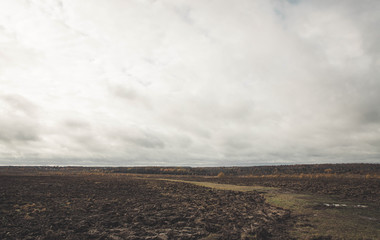 Autumn cloudy weather. Field. A lot of clouds. yellow colors