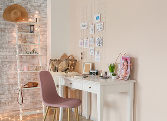 Comfortable workplace with mood board in room