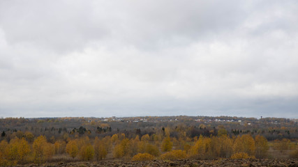 Autumn cloudy weather. Field. A lot of clouds. yellow colors