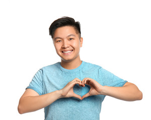 Portrait of Asian man making heart with hands on white background