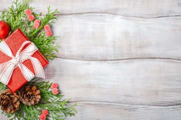 Christmas background with red gift box on a wooden background. Winter festive concept. Top view, flat lay, copy space.