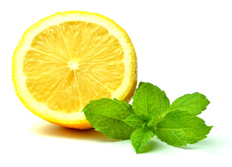 Half pieced lemon and fresh mint leaves isolated on white background. Close-up.