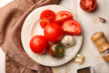 Plate with fresh tomatoes on wooden table